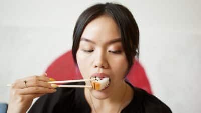 Woman eating sushi