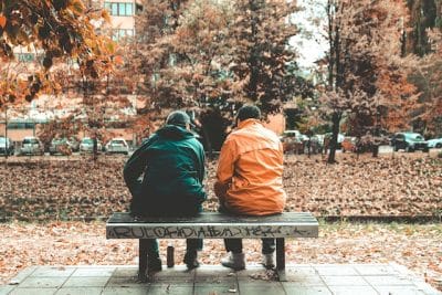 Two people sitting on bench