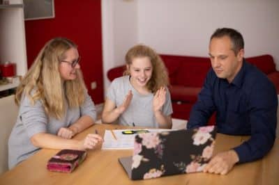 Family laughing at table
