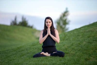 Woman meditating on grass