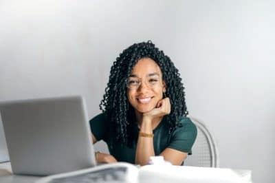 Woman smiling at laptop