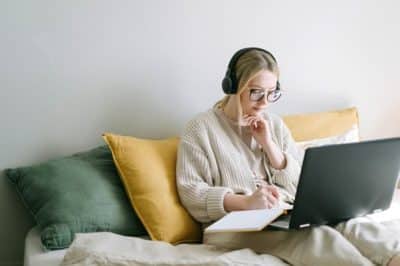 woman sitting on couch on laptop
