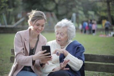 Woman and elderly woman in park