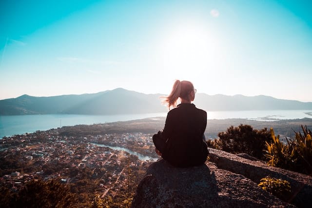 Woman sitting on mountain